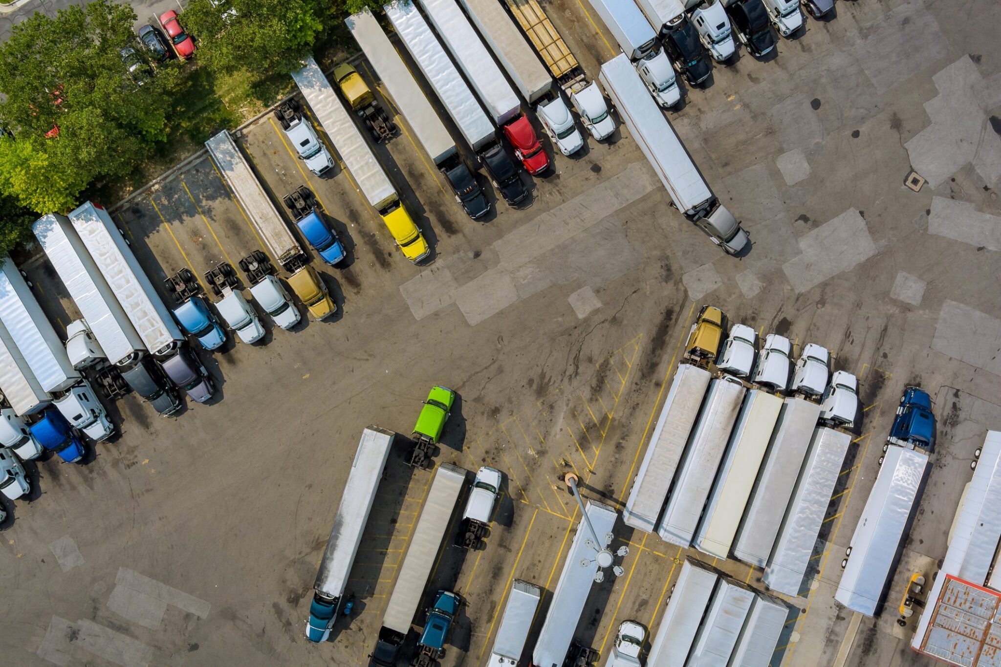 Aerial view of tractors and trailers parked in a commercial truck yard